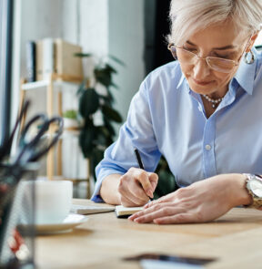 A woman writing on a piece of paper